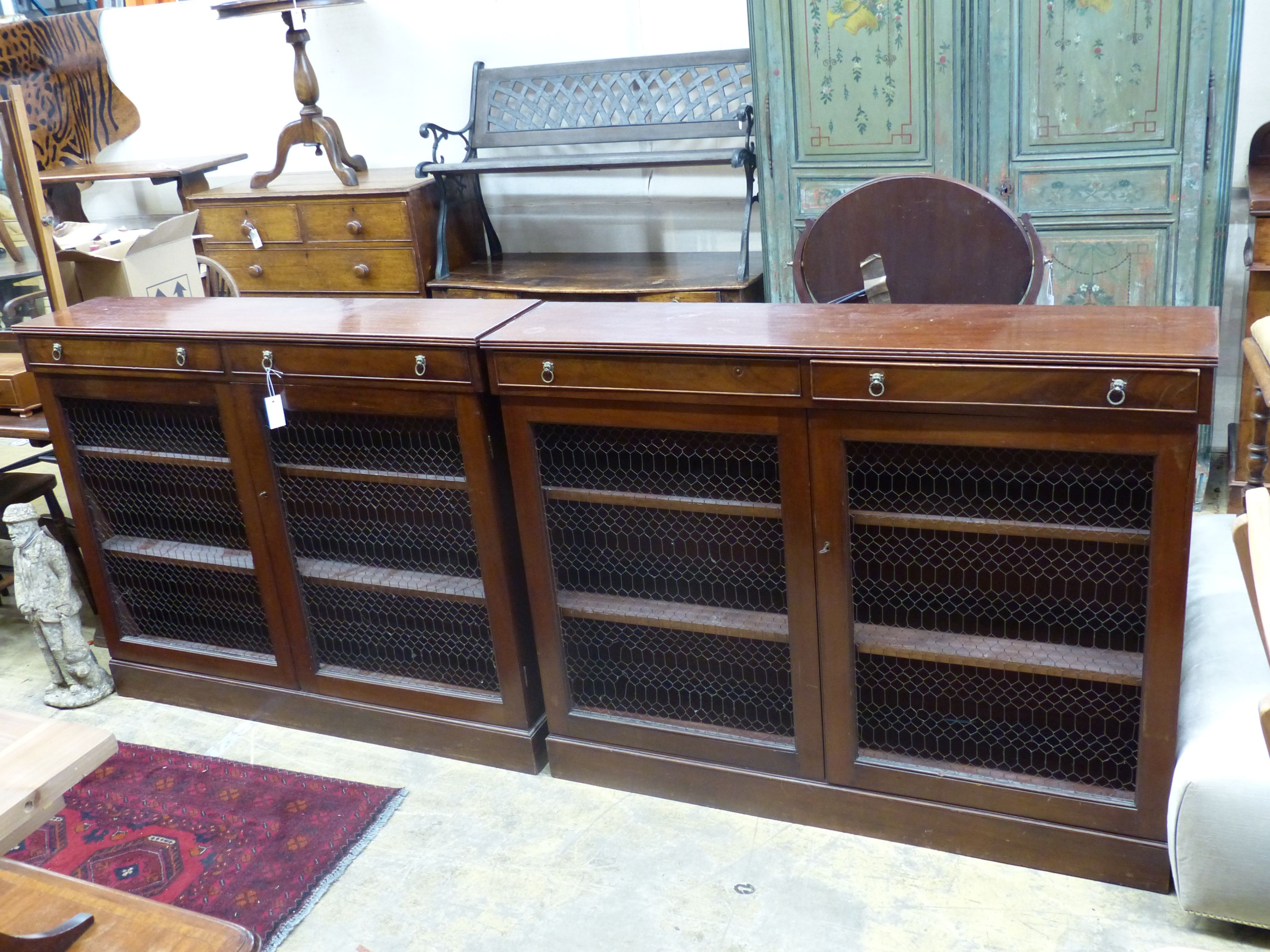 A pair of Regency style mahogany side cabinets, width 131cm, depth 28cm, height 104cm